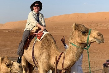 An image of the blind teacher who died of COVID astride a camel